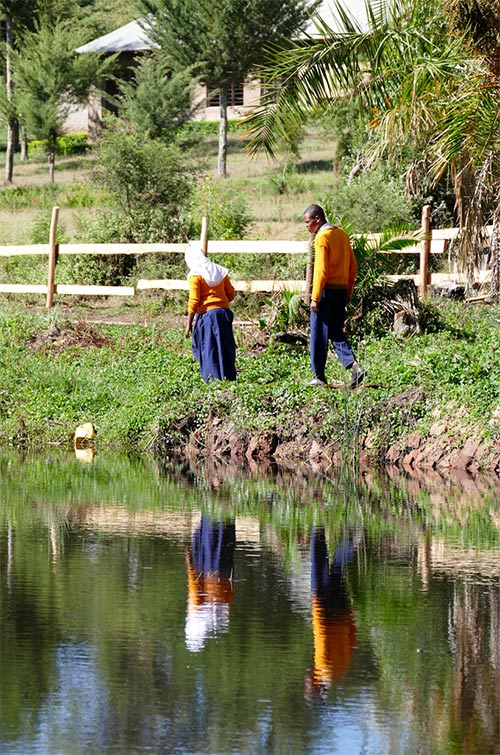 youth walking near pond